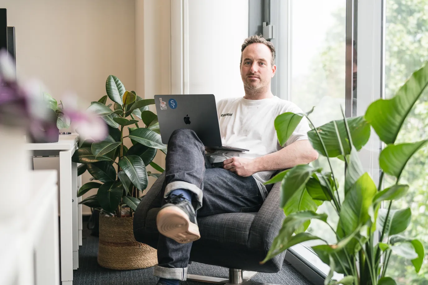 Samaya AI employee sitting in a comfortable chair working on a laptop