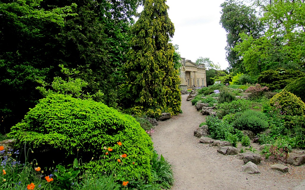 I'm not sure if it's any shorter, but it certainly a nicer walk than just going down the street.