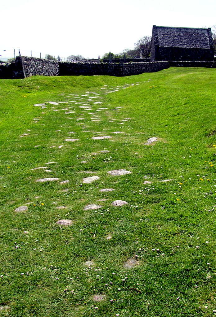 This is the Road of the Dead. It originally led from the Bay of Martyrs, back by the village, up to the abbey, and is the route that chieftains would be carried for burial at the abbey. Most of the road is underneath the current ground level, but this section, near the abbey, is all that remains above ground.