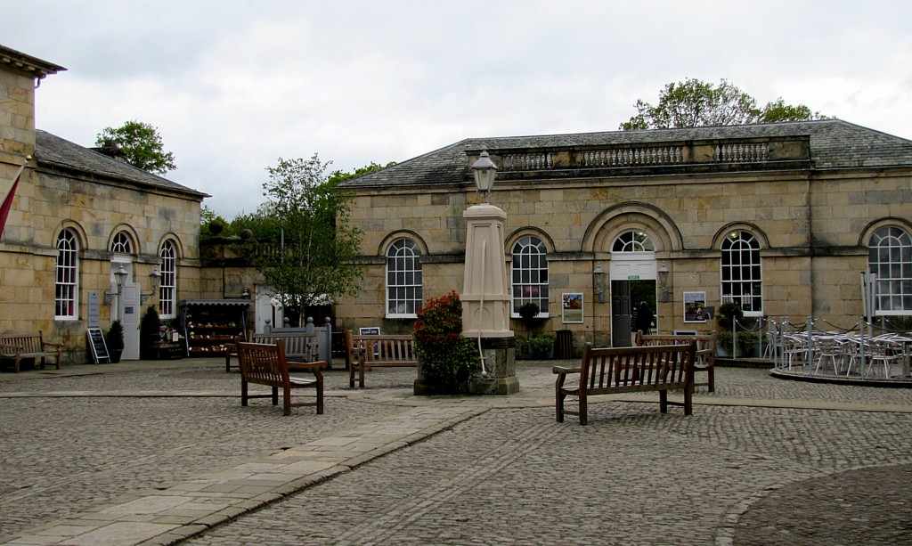 Inside the stable courtyard. There are shops, a cafe, toilets, benches, and an actual butcher's shop.