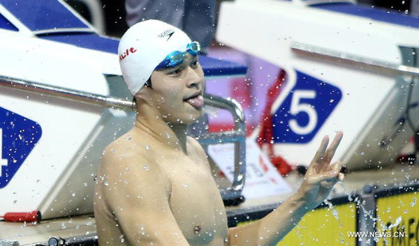 Sun Yang of Zhejiang celebrates after winning the men's 200m freestyle final of the 12th Chinese National Games in Shenyang, northeast China's Liaoning Province, Sept. 6, 2013. Sun Yang won the gold and set a new Asian record with a time of 1 minute 44.47 seconds. (Xinhua File Photo