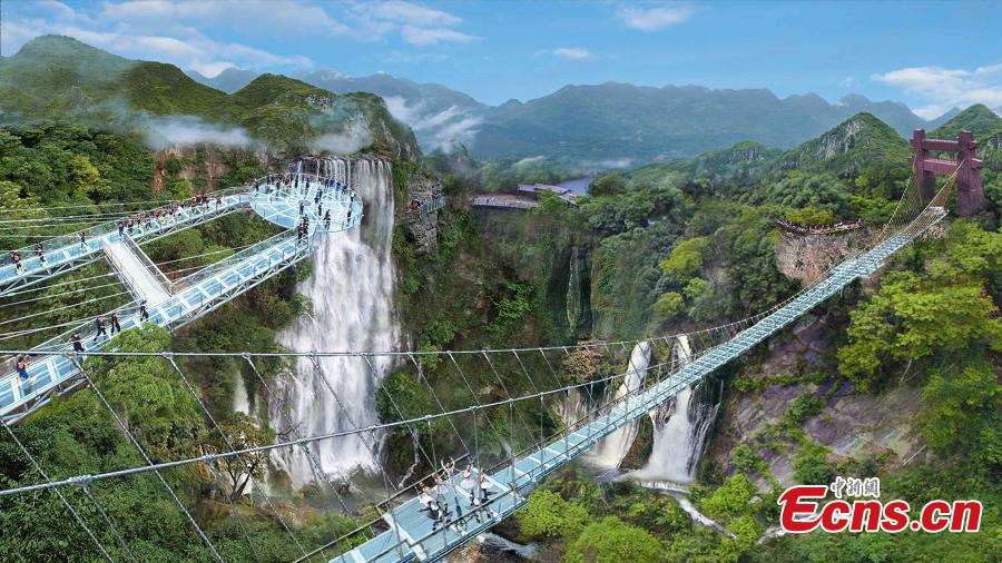 An aerial view of a glass viewing platform along a cliff at the Gulongxia scenic spot in Qingyuan City, South China\'s Guangdong province, June 28, 2018. The structure also features a massive circular glass observation deck suspended at the end of the bridge, jutting out 72 meters from the cliff edge. (Photo: China News Service/Xu Qingqing)