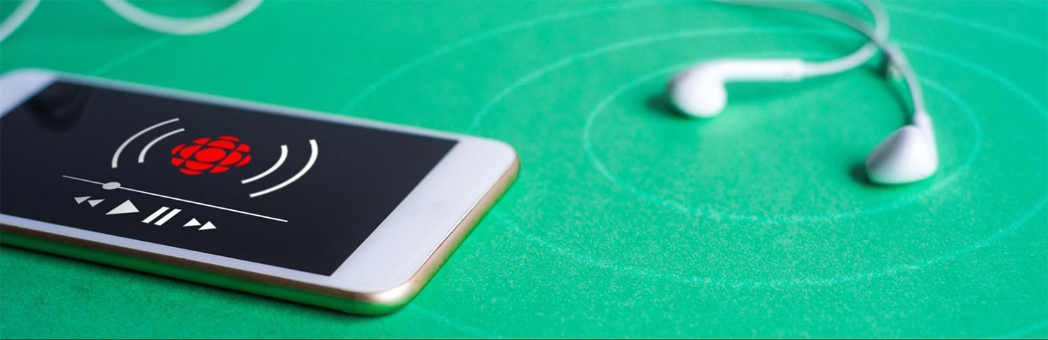 Mobile phone and ear buds on green background