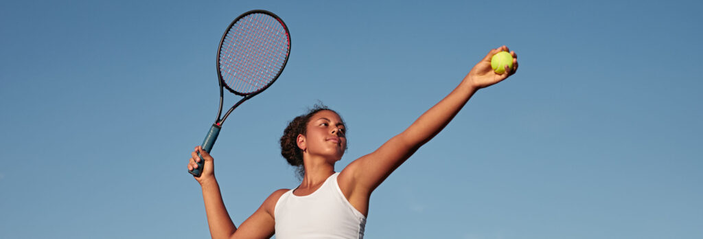 woman hitting tennis ball