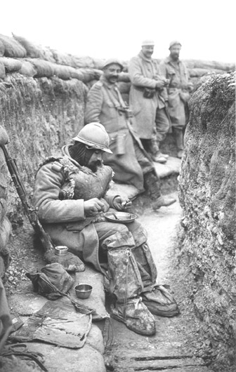 This look-out, covered in winter and waterproof garments, sits down with his much deserved meal. Nieuport.