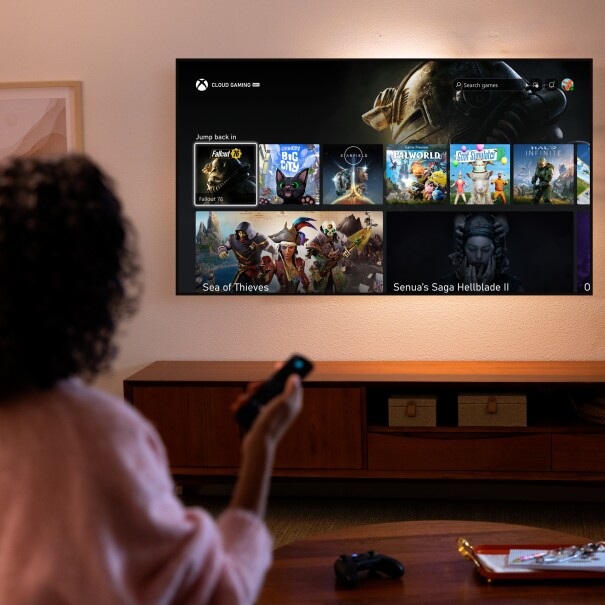 Xbox Gaming: mujer con un Fire Stick TV cambiando el canal de TV