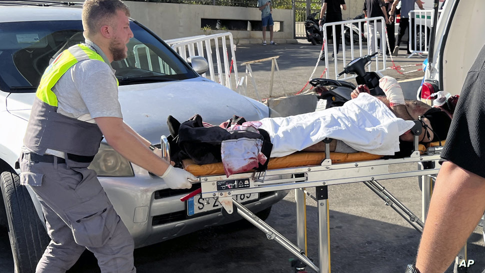 A Civil Defense first-responder carries a wounded man whose handheld pager exploded at al-Zahraa hospital in Beirut, Lebanon,…