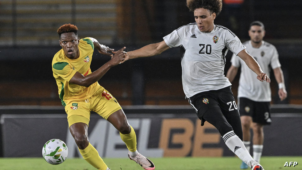 Libya's forward #20 Osama Mukhtar (R) fights for the ball with Benin's #18 Junior Oshola during the CAF Africa Cup of Nations …