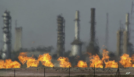 FILE - In this Jan. 24, 2004 file photo, fires flare off the gas from crude oil at Iraq's oldest oil processing plant in the…