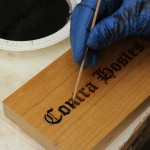 Laser etching being filled with colored resin