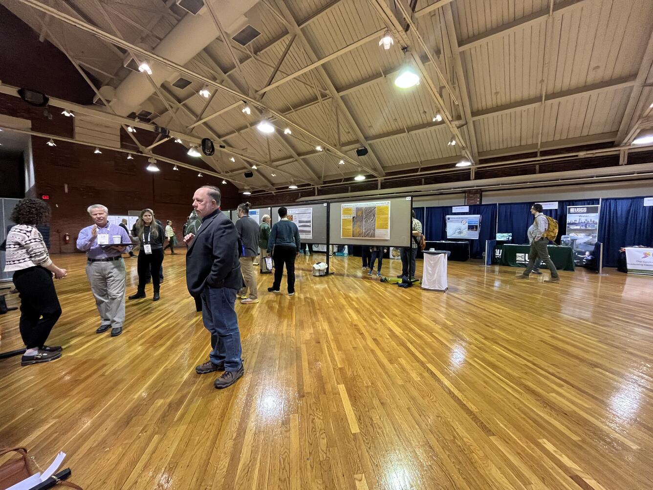 An auditorium with hanging posters and people.