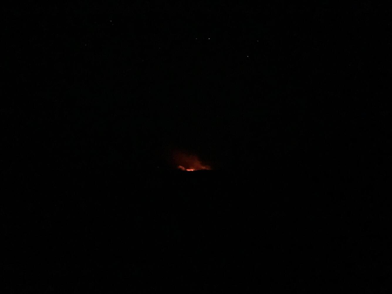 Color photograph of eruption plume and stars