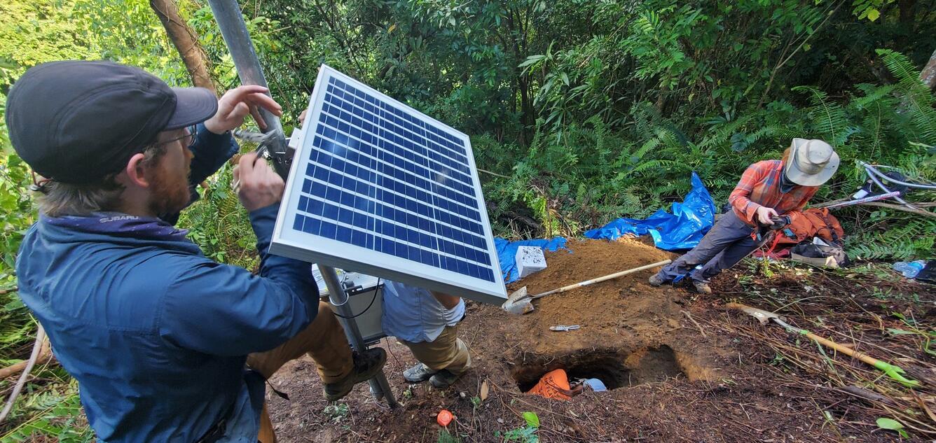 USGS scientists install a solar panel and characterize soils