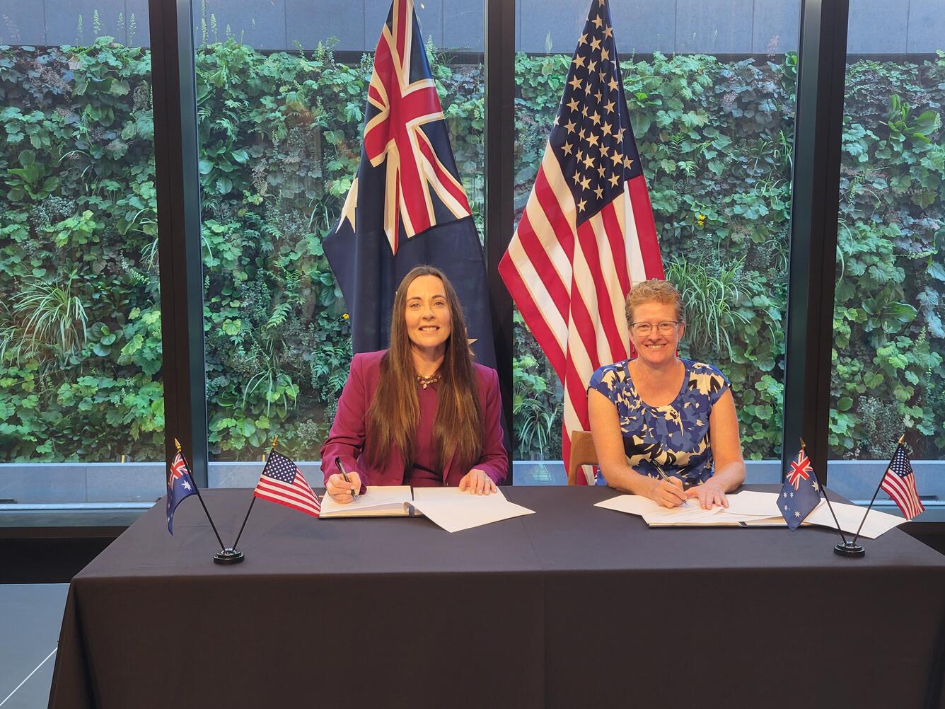 Alison Rose, Geoscience Australia, and Darcee Killpack, USGS sign a Memorandum of Understanding for Landsat Next partnership.