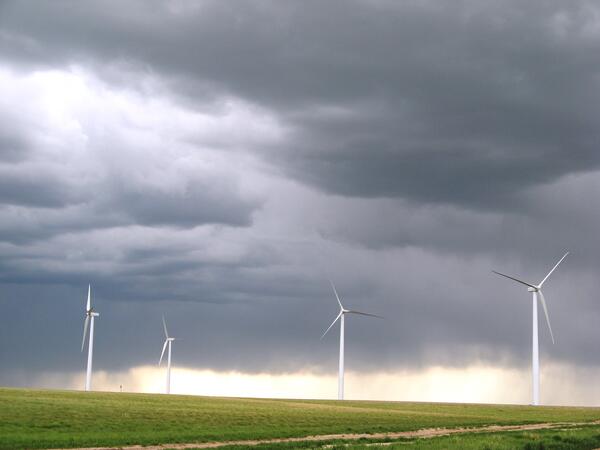 A field of wind turbines in Wyoming with a storm rolling in.