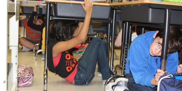 Kids under desks in a classroom