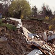 Damaged house fallen off of hillside