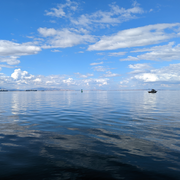 blue water with clouds above