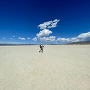 scientist walking in desert with equipment