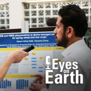 A man's profile in front of a science poster with a microphone being held in front of him and a logo placed on top of him