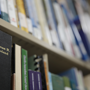 Books on a shelf. one black spine of a book says "Thomas R. Loveland"