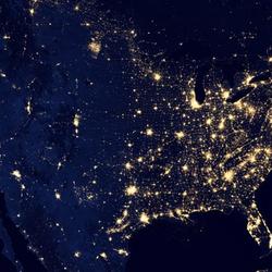 dark background image of US from space showing lights in cities