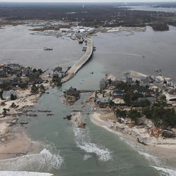 Aerial photograph of Hurricane Sandy storm damage at Mantoloking, New Jersey coastline - bridges. roads and houses destroyed.