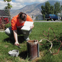 USGS employee taking a measurement on a domestic groundwater well