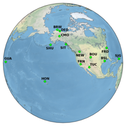 globe with triangle symbols and labels for geomagnetic observatory locations