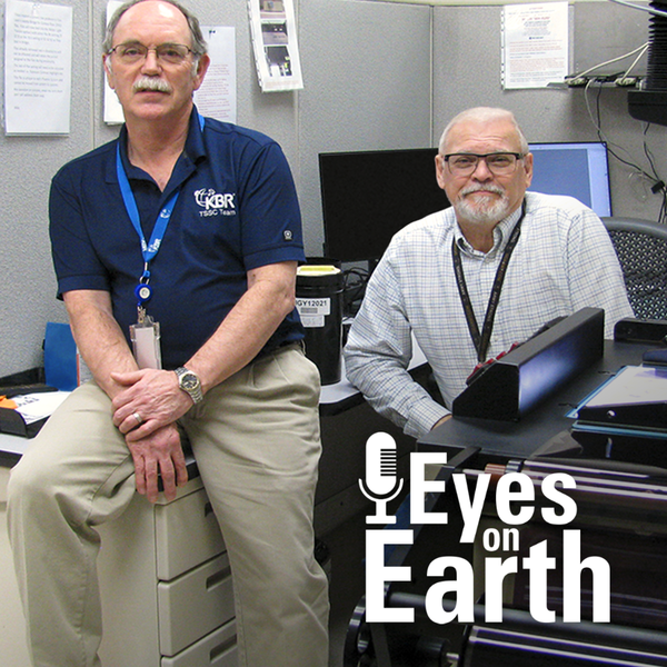 Two men sitting and posing in an office setting