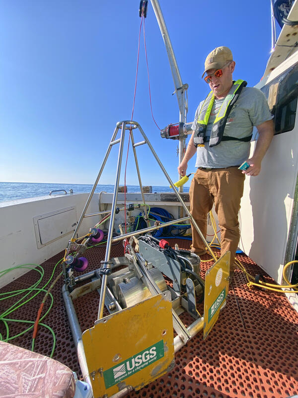 man standing on a boat deck surrounded by equipment