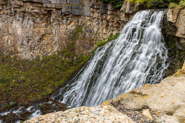 Large amounts of water flowing over rocks down to a stream