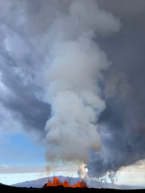 vertical plume of smoke coming out of lava fountain