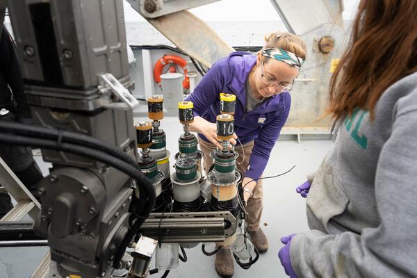 Image shows a woman unloading equipment from an ROV