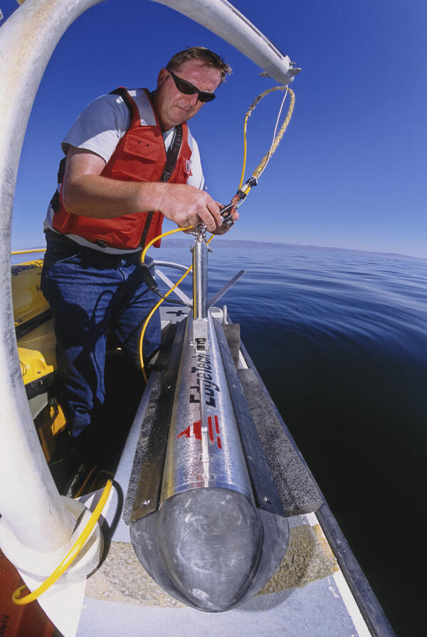 Photo of USGS scientist Robert Baskin deploying a side scan sonar in the Salton Sea, California. 