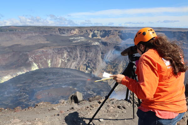 A geologist uses a laser rangefinder to measure the elevation of the active lava lake in Halema‘uma‘u crater