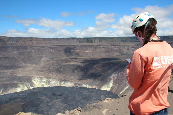 Color photograph of scientist monitoring eruption