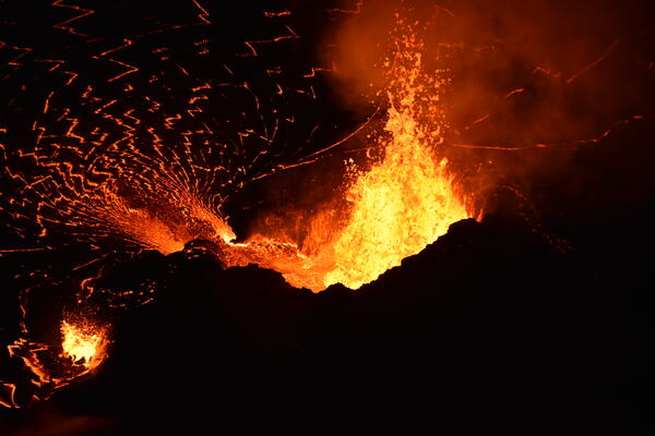 Low-light telephoto color image of lava fountains supplying lava into lava lake