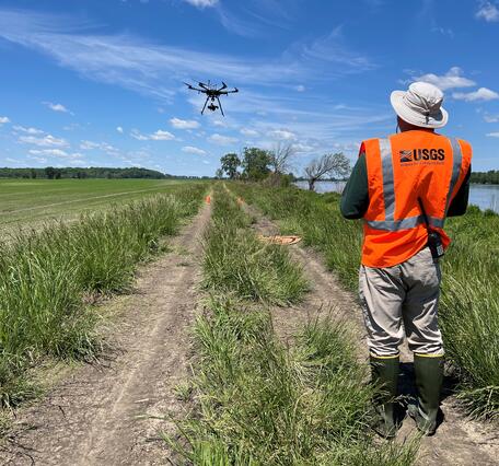 NUSO remote pilot flies a UAS with hyperspectral payload from a levee on the south bank of the Missouri River.