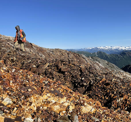 Geologist approaches an old exploration trench on the east flank of Marsha Peak in the Stikine River corridor, Alaska 