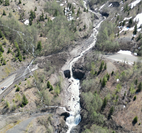 Aerial view of highway blocked by mud, water, and debris