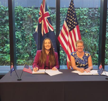 Alison Rose, Geoscience Australia, and Darcee Killpack, USGS sign a Memorandum of Understanding for Landsat Next partnership.