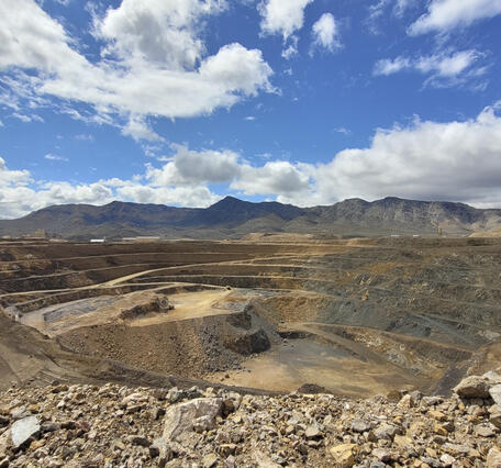 Open pit rare earth element mine at Mountain Pass, California. Stepped sides of the pit and access for mining vehicles shown.