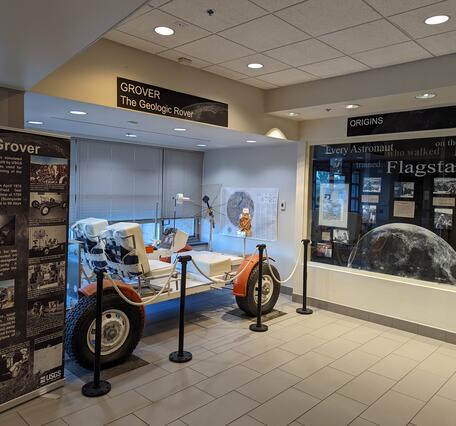 A moon rover on display in the lobby of Astrogeology science center, with interpretive displays.