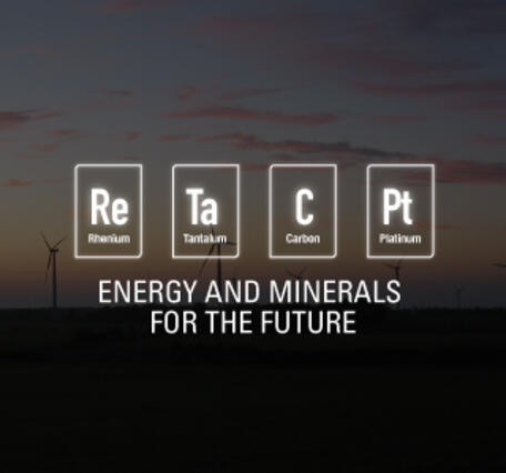 Energy and Minerals for the Future with mineral commodity icons with wind turbine field during sunset