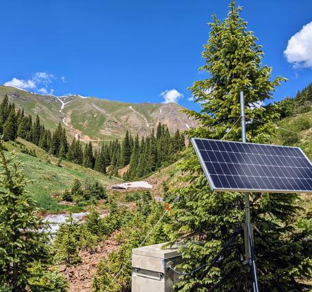 Instrumentation set up in a valley near a mountain. 