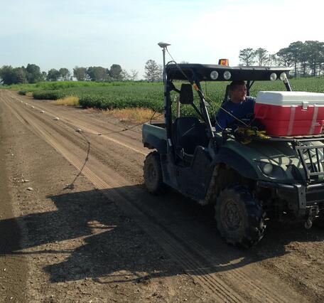 Jason Payne driving an ATV pulling an array of electrodes for mapping the near surface geology in the vicinity of Steiner, MS