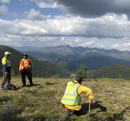 Geologists discuss the district-scale geology during a field visit at Pogo Mine, Alaska