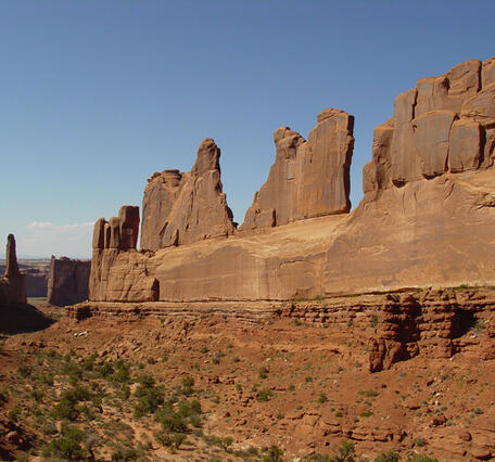 Desert landscape with sandstone cliffs and blue sky