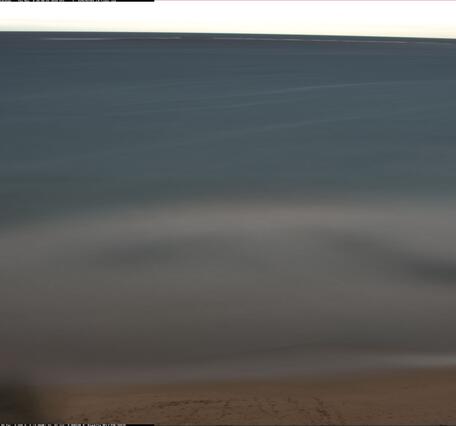 Time exposure image shows a beach with a blurry area where waves were breaking, over a 10-minute period.